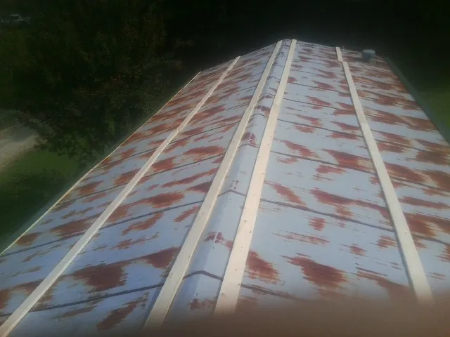 Rusted metal roof panels with new wood purlins before replacement — Storm Damage Roof Repair in Pennsylvania Furnace by Roofing Brothers