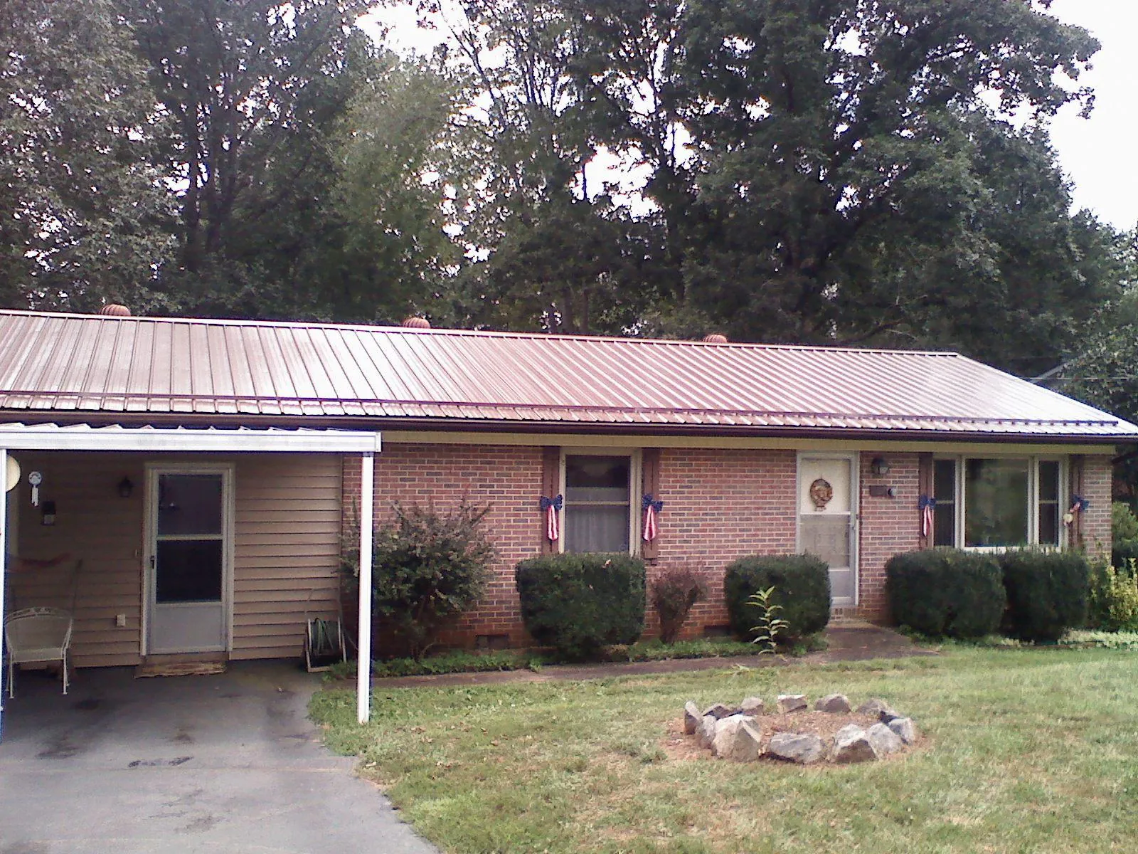 Bronze metal roof and carport on a brick ranch home — Roof Repair work by our crew in Pennsylvania Furnace